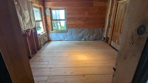 The Unfinished Room (off the living room, abutting the library, looking out on the back cove).